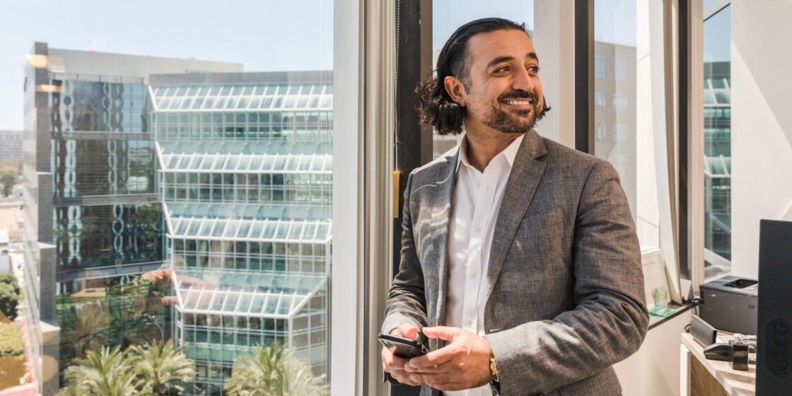Image of man in suit holding phone