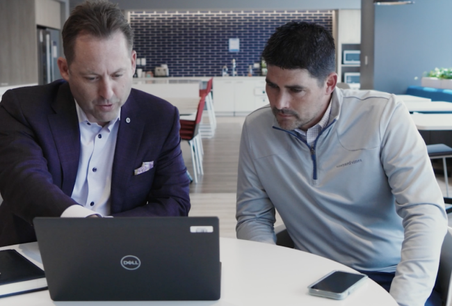 Screengrab of BMO Case Study video featuring BMO employees at laptop computer