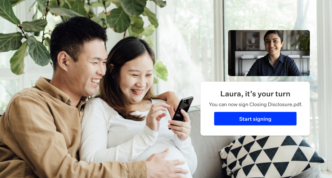 Man and a pregnant woman looking at phone with overlay message say that it Laura's Turn, she can sign the closing document