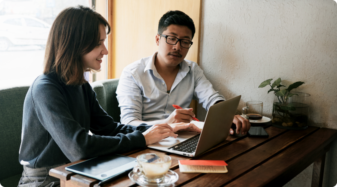 Image of man and women sitting together in front of laptop