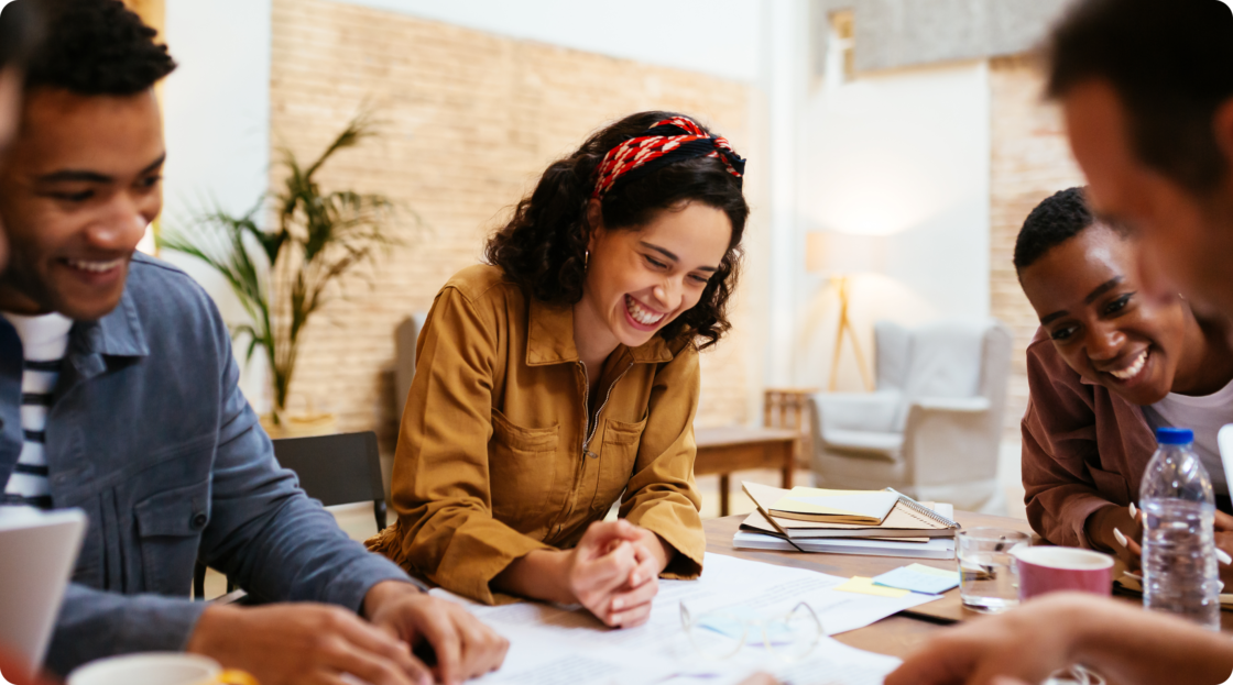 Image of two women and two men working together at a table