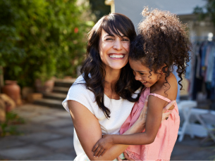 Woman smiling holding child
