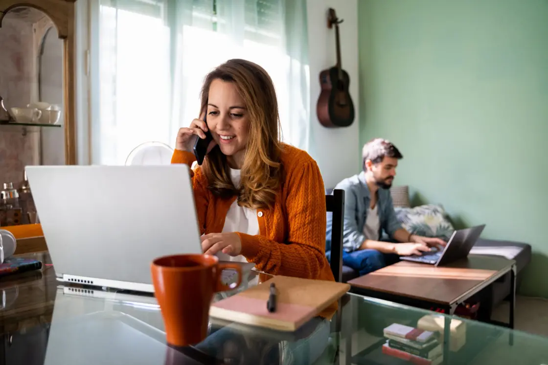 Happy young couple working remotely from their home during lockdown